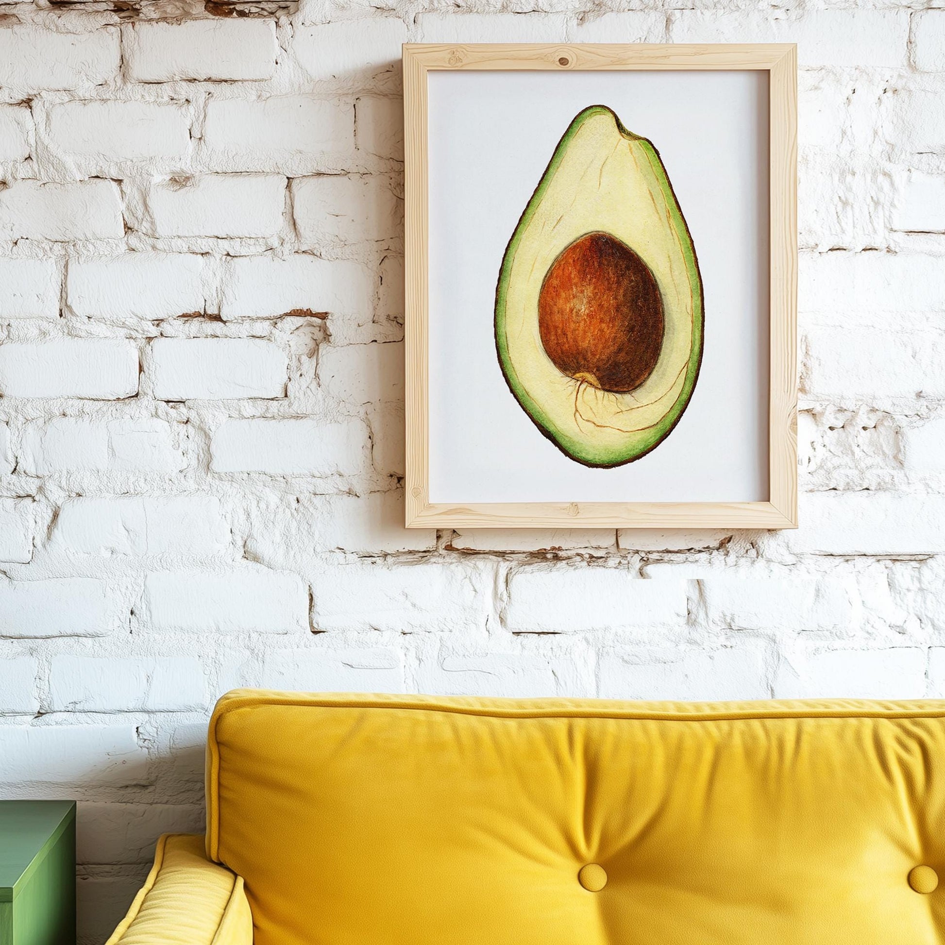 Avocadoposter aan witte muur van bakstenen. Ervoor staat een gele bank.